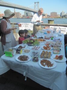 table at potluck honoring Roy Felshin at East River Park on shore of East River
